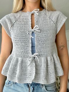 a woman wearing a crochet top with an open back and tie at the waist