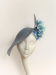 Pale blue saucer disc hat Pale blue saucer disc hat is a one-off. Pale blue Saucer Disc Hat will be an amazing accessory to compliment your outfit. It's very elegant and original. Pale blue saucer disc hat will fit average head size. It's made from a light blue sinamay saucer base. On the side of it sits amazing hydrangea flowers. To secure your fascinator there is a headband and a comb inside the hat, so the fascinator sits very securely on your head. Enjoy your special day with this beautiful headpiece and please have a look at my other fascinators and hats in my shop. Kristine xx https://www.etsy.com/uk/shop/KristineRosahats?ref=profile_header Navy Blue Fascinator, Navy Fascinator, Royal Ascot Races, White Fascinator, Fascinator Wedding, Blue Fascinator, Kentucky Derby Fascinator, Royal Ascot Hats, Derby Hats Fascinators