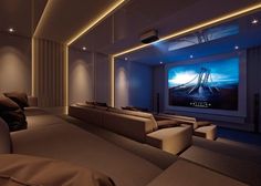 a room with couches and a large screen