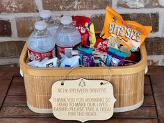 a wooden basket filled with water and snacks