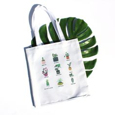 "The perfect tote for the plant lover in your life, even if (or especially if?) that's you.  This handprinted tote bag is sturdy, versatile, and features our original plant personalities illustration.  Constructed using 100% polyester canvas from 50% recycled materials, this tote also features a coated interior that can be wiped clean. Measures 14.5\" tall and 13.5\" wide with an 11\" handle drop. Permanent sublimated image is absorbed by the polyester fabric, meaning it is not raised and will n Everyday Rectangular Bag With Plant Print, Botanical Canvas Bags For Everyday Use, Rectangular Bags With Plant Print For Daily Use, Botanical Style Canvas Bags For Everyday Use, Eco-friendly Everyday Bag With Plant Print, Eco-friendly Rectangular Bag With Plant Print, Botanical Style Canvas Tote Bag For Daily Use, White Botanical Tote Bag, Botanical White Tote Bag