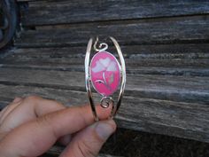 "This lovely, silver cuff bracelet is extremely beautiful! It has a flower inlay, in pink and white. This bracelet is adjustable. It would fit any small or medium woman. It is marked Alpaca Mexico. The bracelet was made in the 1970's and measures 1\" at its widest point. This would make an awesome birthday, Christmas, or Mother's Day gift! Please let me know if you have any questions. All jewelry items come in a gift box." Adjustable Pink Bangle As A Gift, Silver Cuff Bracelet Bangle For Bridesmaids, Handmade Pink Cuff Bracelet For Gift, Pink Adjustable Bangle For Gift, Silver Cuff Bracelet For Bridesmaid Gift, Adjustable Pink Bangle For Gift, Silver Cuff Bangle For Bridesmaid Gift, Silver Flower Cuff Bracelet For Gift, Bohemian Pink Cuff Bracelet As Gift