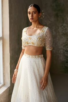 Ivory skirt with aari, sequin, thread embroidery in floral pattern. Paired with embroidered padded blouse and dupatta. - Aza Fashions White Embellished Blouse For Reception, Traditional White Sequined Blouse, White Sequined Choli For Reception, Fitted White Choli With Floral Embroidery, Fitted White Sequined Lehenga, Fitted Choli With Pearl Embroidery For Festive Occasions, Fitted Pearl Embroidered Choli For Festive Occasions, Elegant White Choli With Floral Embroidery, Fitted Embellished White Lehenga