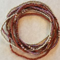 "Seed bead stretch bracelets come in a set of 8. Toho seed beads In shades of mud brown, terra cotta, gold and burnt orange. Wear them all together or mix and match depending on your outfit. Beautiful boho bracelet set. - Toho seed beads - Custom sizes available - Seed bead sizes are 11/0 - Elasticated on strong stretch cord - Gift bag - All orders are hand crafted in a smoke free home. Ships within 24 hours **SIZING** Bracelets are made to the standard sizing of 7.0\". One fits most. If you nee Earthy Brown Beaded Bracelets With Round Beads, Bohemian Brown Stretch Bracelet With Spacer Beads, Colorful Beaded Bracelets With Round Beads, Brown Heishi Beads Jewelry With Tiny Beads, Brown Beaded Stretch Bracelet With Round Beads, Bohemian Beaded Bracelets With Flexible Round Beads, Brown Stretch Bracelet With Faceted Beads, Adjustable, Adjustable Brown Stretch Bracelet With Faceted Beads, Brown Heishi Beads Bracelet