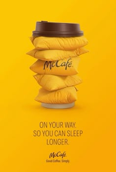 an advertisement for mcdonald's coffee with a stack of pillows on the side and a cup in the middle