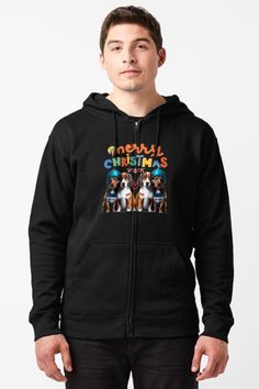 a man wearing a black zip up hoodie with an image of dogs on it