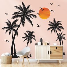 a wall mural with palm trees and birds flying in the sky, against a pink background