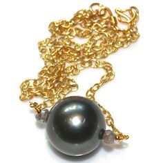 "This amazing natural green Tahitian pearl necklace will be a fast favorite. A gorgeous naturally colored large gem quality Tahitian pearl is accented with shimmery labradorite on a gold vermeil chain. This necklace measures approximately 16\". Sublime!! xoxoxo payton For more cool jewelry looks, check out http://www.etsy.com/shop/FizzCandy All FizzCandy creations come beautifully boxed and ready for gift giving. Please see our store policies here - https://www.etsy.com/shop/FizzCandy/policy?ref High Luster Tahitian Pearl Necklace, Tahitian Pearl Charm Necklace With Round Pendant, Tahitian Pearl Necklace With Round Pendant And Pearl Charm, Gold Necklace With Tahitian Pearl Round Beads, Gold Tahitian Pearl Necklace For Anniversary, Tahitian Pearl Necklace With High Luster Round Beads, Tahitian Pearl Briolette Necklace For Gifts, High Luster Tahitian Pearl Necklace With Round Beads, Tahitian Pearl Drop Necklace As Gift