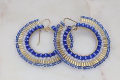 Handmade colorful boho statement earrings in the most gorgeous mix of cobalt blue, gold, and white. These artisan beaded hoop earrings were made with several sizes and shapes of seed beads. Each tiny bead is selected and hand sewn into place, one at a time with a needle and thread. No plastics, no glue, no looms - completely hand stitched with strong nylon thread.✔️Ear wires are gold filled✔️handmade in the USA✔️ships boxed and ready to gift in 3-5 business days ✔️lightweight & comfortable✔️LENG Beaded Hoop Earrings, Beaded Hoops, Colorful Boho, Blue And Gold, Needle And Thread, Hand Stitched, Ear Wires, Cobalt Blue, Hand Sewn