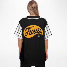 Can you dig it?Simply great to skyrocket any outfit, The Furies Black Baseball Jersey - The Warriors Riverside Gang features TimeElements design The Furies '79. Riverside park's infamous underground baseball team (The Warriors 1979) revives in this groovy jersey. A great addition to your wardrobe to complete your oddball outfits. Stylish, essential, wicked.Features:• TimeElements design The Furies '79 • 100% polyester• Rounded hem• Button-front closure• Moisture-wicking fabric for a lightweight, Black Varsity Baseball Jersey For Baseball Season, Collegiate Black Baseball Jersey For Streetwear, Black Cotton Baseball Jersey With Team Logo, Casual Black Baseball Jersey With Team Logo, Streetwear Tops With Team Logo And Baseball Collar, Varsity Black Baseball Jersey With Crew Neck, Black Baseball Jersey For Streetwear During Baseball Season, Throwback Black Tops For Baseball Season, Black Crew Neck Baseball Jersey With Team Logo