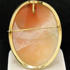 Here we have a very nice vintage cameo pendant or brooch. The frame is solid 14k yellow gold and features a simple polished finished. The pin and locking mechanism on the back are in perfect working order. The bail on the back of the piece swivels up for wear as a pendant or down when wearing it as a brooch. The inside of the bail measures approximately 4.8x3.5mm. (Please be sure to take into account areas of a clasp that may be thicker than the chain itself when measuring your chain.) A very ni Classic Oval Cameo Brooch, Oval Cabochon Brooches For Anniversary, Oval Yellow Gold Brooches With Gemstone, Yellow Gold Oval Cameo Brooch, Oval Cameo Brooch For Anniversary, Classic Gold Oval Brooch, Classic Gold Oval Brooches, Classic Oval Gold Brooches, Classic Oval Cabochon Brooches