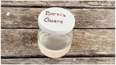 a bottle filled with water sitting on top of a wooden table