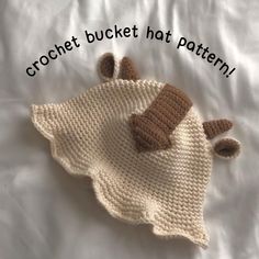 there is a crochet baby hat on the bed