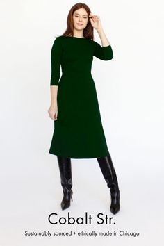 Model is 5'11" wearing size M. Mediumweight dress with a slightly flared skirt. Made with sustainable and significantly more ethical Better Initiative Cotton (BCI) interlock knit fabric. Machine washable | Medium-heavy weight | Interlock knit fabric. Sustainably sourced, ethically made in Chicago, USA. Fitted Green Sweater Dress Midi Length, Green Fitted Midi Length Sweater Dress, Fitted Green Midi Sweater Dress, Green Fitted Midi Sweater Dress, Green Midi Length Stretch Sweater Dress, Green Stretch Midi Sweater Dress, Fall Midi Dress In Elastane, Winter A-line Stretch Midi Dress, Turtleneck Stretch Midi Dress For Work