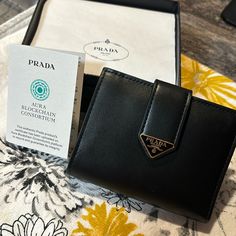 Brand New Small Saffiano Smooth Black Leather Wallet. Bought In Italy In Early October. Brand New!!! Comes With Certificate Of Authenticity, Card Inserts, And Original Box With Tissue Paper. Smoke Free Home. Smooth Black Leather Gold Signature Triangle Emblem And Buttons. Free Shipping Retails 750 On Prada Website. *Will Go Directly To Poshmark Hq To Be Authenticated Before It Comes To You!!* Everyday Wallets With Logo Plaque, Designer Evening Wallets With Logo Plaque, Designer Evening Wallets With Rfid Blocking, Designer Rfid Blocking Wallets For Evening, Elegant Saffiano Leather Wallet With Card Slots, Luxury Saffiano Leather Wallet For Evening, Elegant Saffiano Leather Bifold Wallet, Elegant Evening Wallet In Saffiano Leather, Designer Saffiano Leather Wallets For Formal Occasions