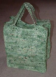 a green crocheted bag sitting on top of a floor