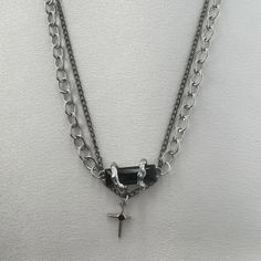 Add a touch of bold and edgy style to any outfit with our Double Layer Star Pendant Necklace. Perfect for both men and women, this streetwear accessory boasts a unique unisex design. Show off your individuality and make a statement with this eye-catching piece. Necklace length 18.0 inch with 1.9 inch extension chain, Chain width 5 mm. Punk Cross Necklace For Streetwear, Punk Streetwear Cross Necklaces, Punk Cross Jewelry For Streetwear, Edgy Adjustable Necklaces For Streetwear, Edgy Adjustable Necklace For Streetwear, Alternative Style Chain Jewelry For Streetwear, Adjustable Emo Streetwear Jewelry, Black Grunge Jewelry For Streetwear, Adjustable Edgy Jewelry For Streetwear