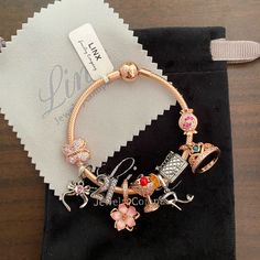 a bracelet with charms on it sitting on top of a table