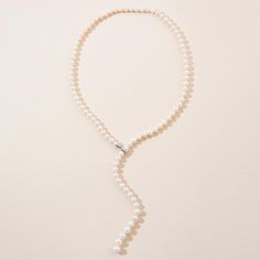 The Adjustable Pearl Lariat Necklace is approximately 27 inches in length with beautifully graduated freshwater pearl gemstones. The pearls are 7mm with the end steadily increasing to larger 10mm pearls. The sterling silver clasp allows you to adjust the graduated strand to a length unique to you. The strand can also be worn down the back to accent that backless dress or as a perfect bridal ensemble. Elegant Lariat Necklace With Pearl Drop, Elegant Long Drop Lariat Necklace With Pearl, Timeless Lariat Necklace For Weddings, Elegant Pearl Charm Lariat Necklace, Luxury Pearl Lariat Necklace, Elegant Long Drop Single Strand Lariat Necklace, Pearl Pendant Lariat Backdrop Necklace, Pearl Lariat Backdrop Necklace With Pearl Pendant, Elegant Pearl Chain Lariat Necklace