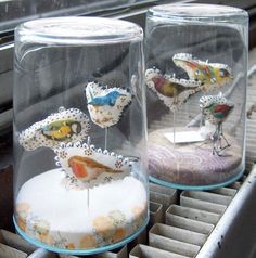 two glass vases sitting on top of a metal rack filled with different types of items