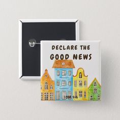 a button that says, we are the good news with houses painted on it in black and white