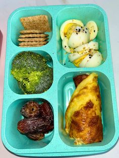 a blue tray filled with different types of food