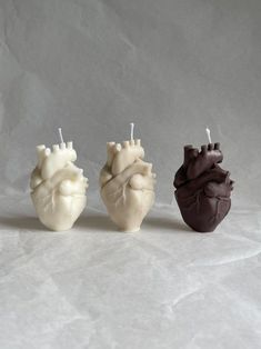 three candles shaped like the human heart