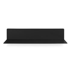 a black shelf sitting on top of a white wall