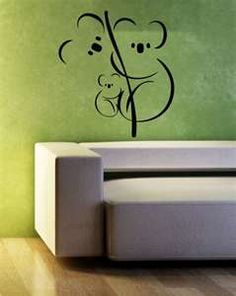 a wall decal with a koala bear holding a tree branch