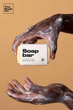 the soap bar is being held by two hands