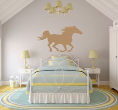 a bedroom with a horse decal on the wall next to a bed and two lamps