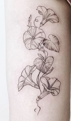 a black and white photo of flowers on the thigh