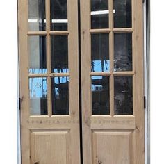 two wooden double doors with glass panels on the front and back sides, both side by side