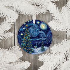 a ceramic ornament with a christmas tree on it and the night sky in the background