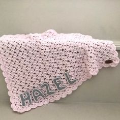 a pink crocheted blanket with the word hale written on it