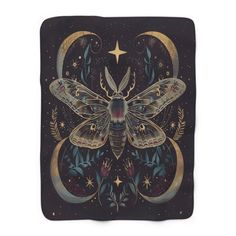 a blanket with a moth on it and stars in the night sky behind it is a crescent