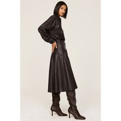 Brown faux leather (100% Polyester, 100% Polyurethane Coating). Skirt. Side button closure. 30" from waist to hemline. Imported. Sleek Knee-length Faux Leather Skirt, Chic Leather Pleated Skirt, Sleek Faux Leather Skirt With Lined Detail, Sleek Faux Leather Lined Skirt, Chic Faux Leather Midi Skirt, Chic Knee-length Faux Leather Skirt, Sleek Leather Midi Skirt, Chic Faux Leather Skirt With Lined Detail, Chic Faux Leather Lined Skirt