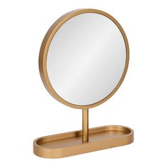 a round mirror sitting on top of a wooden stand