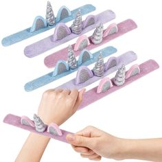 PRICES MAY VARY. SLAP TO WRAP: A blast from the past with an adorable twist! These unicorn slap bracelets are the perfect treats for kids of all ages. Every set comes with 12 pieces, thoughtfully sized to fit most wrists. Dish them out and watch all those cuties beam in glee. RAINBOW OF COLOR: Inspired by all things cute and magical, these unicorn bracelets stand out with lovely shades of pink, purple, and blue. Unicorn lovers will relish the 3D horn and ear design that brightens any day with lo Aaliyah Birthday, Bracelets For Kids, Dragon Birthday Parties, Unicorn Bracelet, Plush Unicorn, Rainbow Unicorn Party, Kids Carnival, 5th Birthday Party Ideas, Rainbow Unicorn Birthday