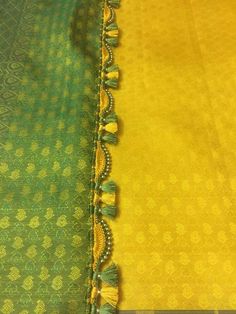 green and yellow sari with tassels on it