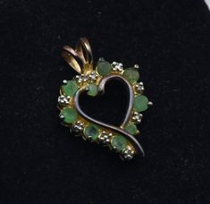 Vintage gold tone sterling silver heart pendant made by Ross-Simons, set with round cut emeralds, alternating with round cut diamonds. Eight emeralds and four diamonds. Six of the emeralds are approximately 2.5mm diameter and two of the emeralds are approximately 2mm in diameter, diamonds are approximately 1mm diameter. NOTE: Gold is rubbing off in areas.  7/8 x 5/8" 2.2g Marked "925 RS CHINA" Sterling Silver Heart Pendant, Silver Heart Pendant, Polish Silver, Diamonds And Gold, Glass Rings, Sterling Silver Heart, Round Cut Diamond, Silver Heart, Vintage Sterling Silver