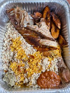 a plastic container filled with rice, meat and other food items on top of it