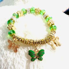 Butterfly Stretchy Green Gold Bracelet Green Beaded Metal Bangle Bracelets, Green Bracelets For Spring Party, Adjustable Green Charm Bracelet For Party, Trendy Handmade Green Charm Bracelet, Trendy Green Handmade Charm Bracelet, Trendy Green Stretch Bangle Bracelet, Spring Metal Bracelets As Gift, Green Beaded Stretch Bracelet, Adjustable Green Bracelets