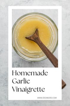 homemade garlic vinaigrete in a jar with a wooden spoon on the side