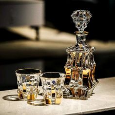 three glasses and a decanter on a table