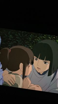 an anime scene with two people hugging each other and flowers in front of the screen