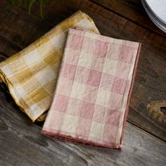 two napkins sitting on top of a wooden table