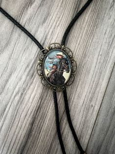 Our handmade western bolo tie has a vintage cowboy with a glass coating. PERFECT for a country men’s bolo tie, wedding sting tie, necktie for groomsmen, or any special person in your life. This bolo tie for men (and women!) has a metal clamp which makes it easy to adjust. *Makes a Great Gift*Pendant Size: 1.5 in x 1.25 inCord in Black Genuine Leather: 39in Riding Black Horse, Bolo Tie Wedding, Western Bolo Tie, Gold Bow Tie, Purple Bow Tie, Green Bow Tie, Plaid Bow Tie, Bowtie And Suspenders, Leather Suspenders