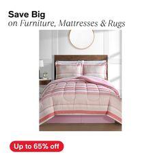 a bed with pink and white striped comforter on it