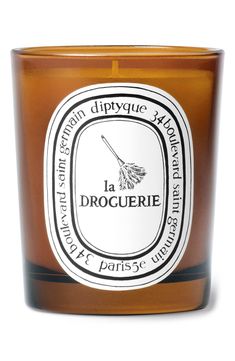 a candle that is brown and white with the words la droguerie on it